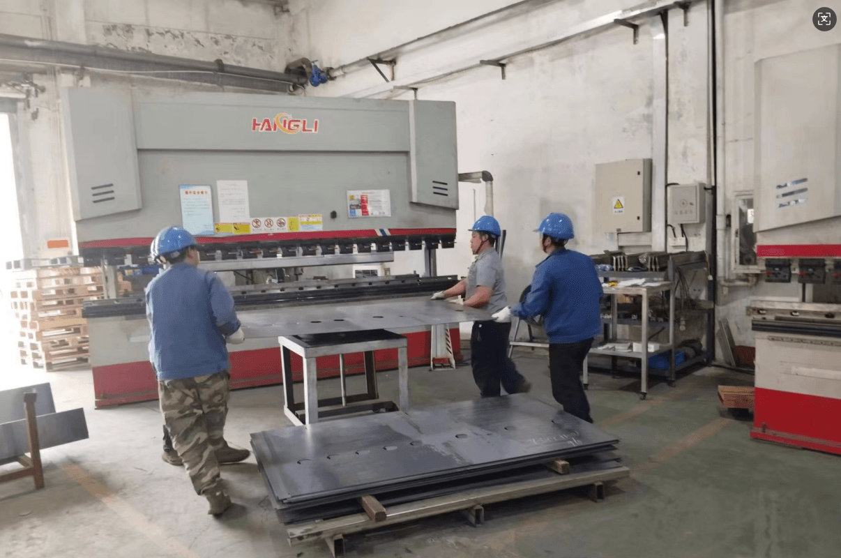 Workers operating HANGLI CNC press brake at HDT factory