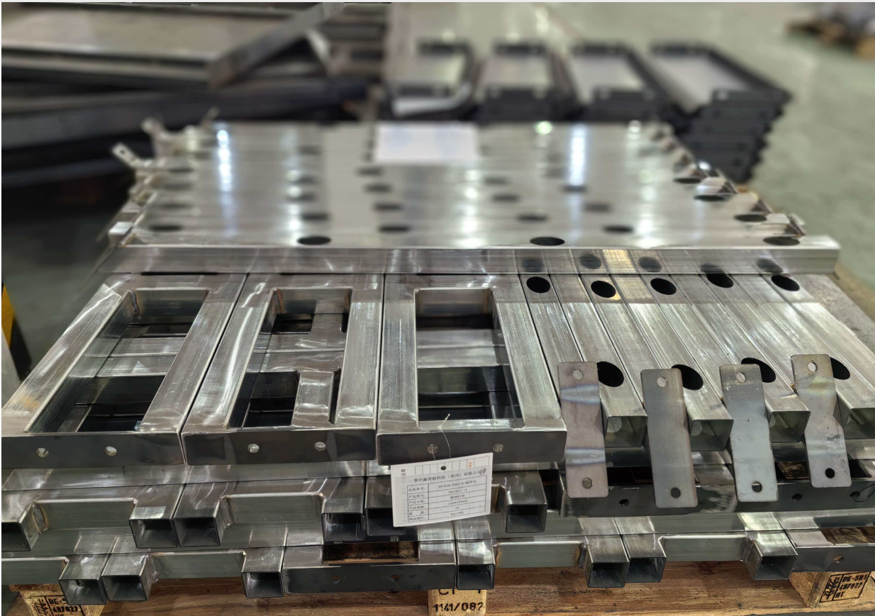 Precision CNC machined metal parts stacked on pallet